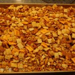 Chex Mix right out of the oven and cooling