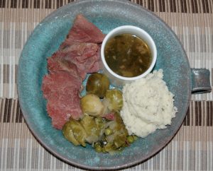 A spin on Jigs Dinner including corn beef, Brussel sprouts and peas, herb mash potatoes, au jus