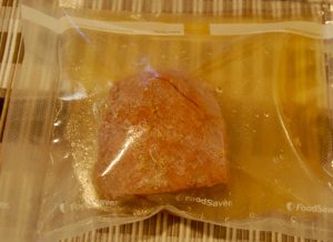 Freeze corn beef with some liquid in a container or vacuum seal bag