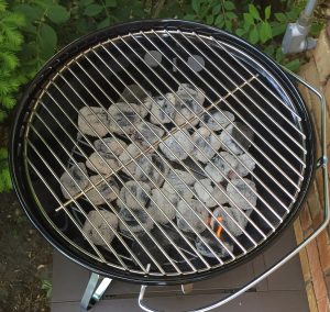 A kettle grill heating up table top