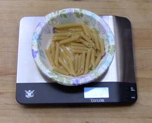 Measure pasta by weight instead of by the cup  or circumference.  A 2 oz portion, dry, is a good starting point