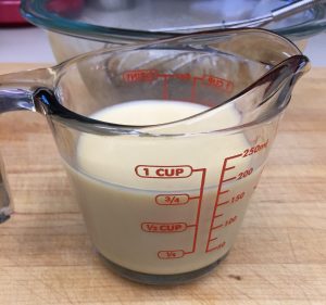 One half a 15 oz can of evaporated milk, or 3/4 a cup.