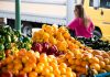 A Survival Guide to Farmers Markets woman at local farmers markets