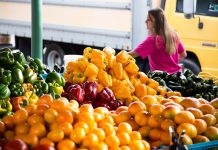 A Survival Guide to Farmers Markets woman at local farmers markets