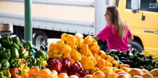 A Survival Guide to Farmers Markets woman at local farmers markets