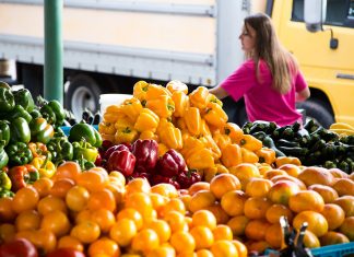 A Survival Guide to Farmers Markets woman at local farmers markets